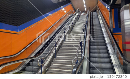 Madrid metro wide view of escalator and stairs with vibrant orange walls for background and urban transport banner design 139472240