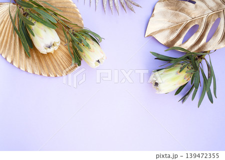 Tropical leaves and flowers over green background, summer background with copy space Tropical leaves and flowers over green background, summer background with copy space 139472355