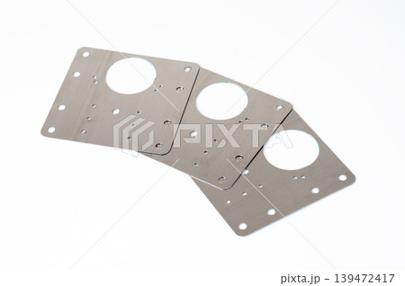 Three stainless steel cabinet hinge repair plates for fixing broken furniture doors, isolated on white background. Three stainless steel cabinet hinge repair plates for fixing broken furniture doors, isolated on white background. 139472417
