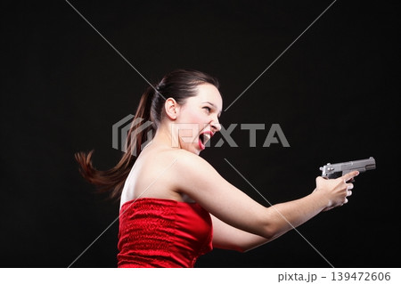Sexy young woman - gun on black background Sexy young woman - gun on black background 139472606