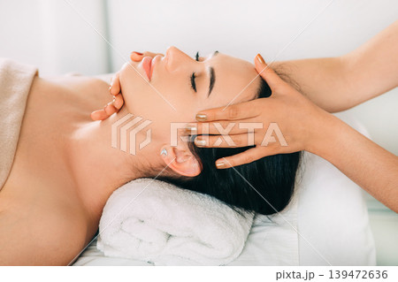 Woman enjoying head massage, face close-up. Relaxing anti-stress massage, treatment head pain 139472636
