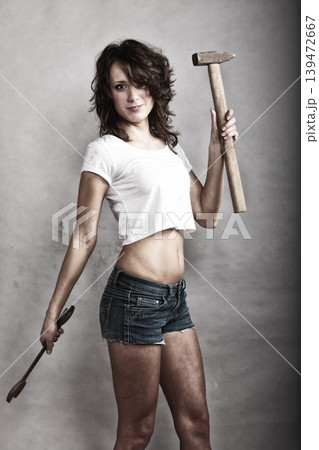 Sexy girl holding hammer and wrench spanner 139472667