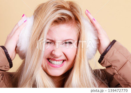 Blonde woman in winter warm earmuffs 139472770