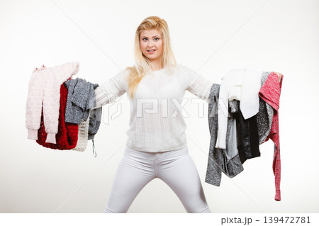 Woman holding many clothing 139472781