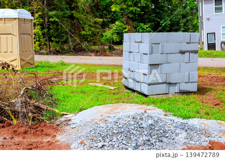 Workers are getting ready to use blocks gravel for construction project at site Workers are getting ready to use blocks gravel for construction project at site 139472789