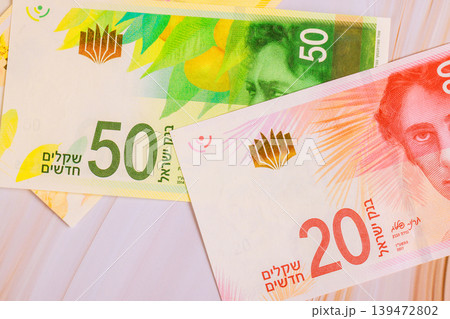 New Israeli shekel NIS banknotes on table under preparation for travel. New Israeli shekel NIS banknotes on table under preparation for travel. 139472802