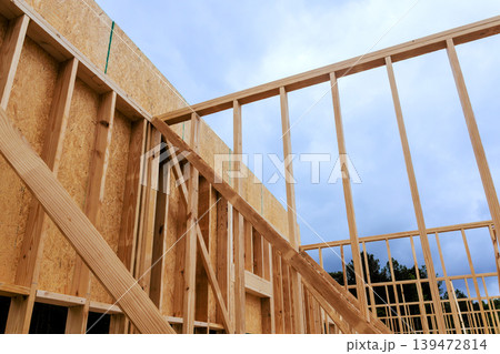 Workers are constructing building with wooden beams frames as under work area Workers are constructing building with wooden beams frames as under work area 139472814