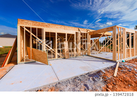 Workers are constructing wooden beams frame for new house at construction site 139472818