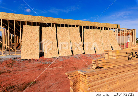 Workers are building structure using wood plywood sheets beams frames at construction site Workers are building structure using wood plywood sheets beams frames at construction site 139472825