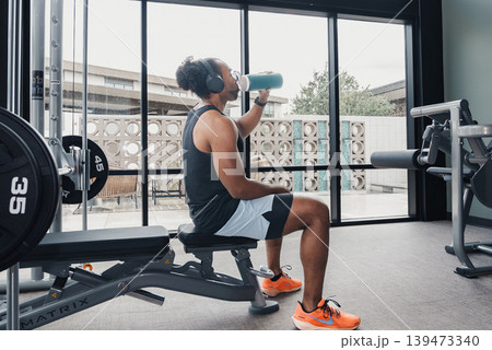 Rehydration Break Activity. Person Drinks Water During Rest Period. Individual Refreshes Themselves During Exercise Pause. Relaxed Person Rehydrates Using Towel During Workout Interval Rehydration Break Activity. Person Drinks Water During Rest Period. Individual Refreshes Themselves During Exercise Pause. Relaxed Person Rehydrates Using Towel During Workout Interval 139473340