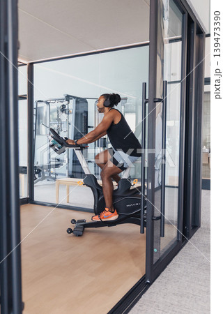 Highintensity Interval Session With Determined Athlete Sweating Profusely. Dedicated Cyclist Pushes Maximum Effort During Rigorous Indoor Training With Concentration And Perspiration 139473390