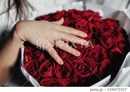 Close View Of Red Blossom Arrangement With Exquisite Jewelry And Soft Lighting. Detailed Shot Of Crimson Flower Cluster Accompanied By Diamond Ring And Gentle Illumination Close View Of Red Blossom Arrangement With Exquisite Jewelry And Soft Lighting. Detailed Shot Of Crimson Flower Cluster Accompanied By Diamond Ring And Gentle Illumination 139473507
