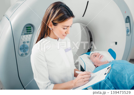 Radiologist write into medical chart after CT Scan Radiologist write into medical chart after CT Scan 139473529