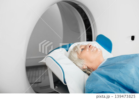 Senior patient at a computer tomography exam Senior patient at a computer tomography exam 139473825