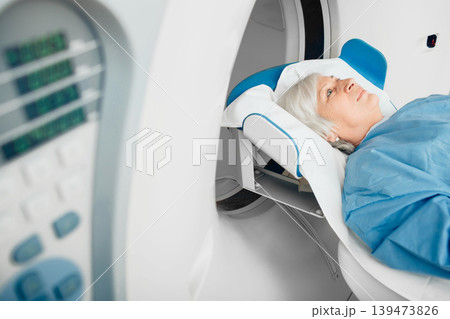 Senior patient at a computer tomography exam Senior patient at a computer tomography exam 139473826
