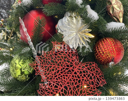 Christmas tree adorned with festive, colorful ornaments and decorative snow-dusted branches Christmas tree adorned with festive, colorful ornaments and decorative snow-dusted branches 139473863