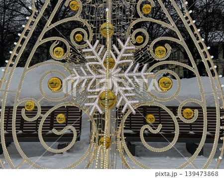 Christmas decorative snowflake with golden accents in winter city park background Christmas decorative snowflake with golden accents in winter city park background 139473868