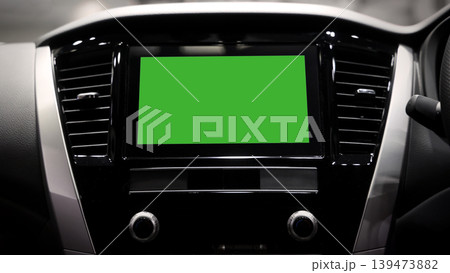 Screen or monitor in car mockup with green. Modern car interior with digital infotainment display and green screen mockup. Dashboard technology touchscreen navigation system. smart car interface tech 139473882
