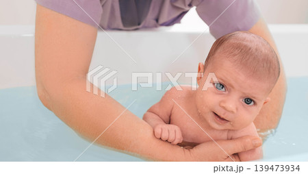teaches infant baby to swim. Aquatic therapy for infant baby teaches infant baby to swim. Aquatic therapy for infant baby 139473934