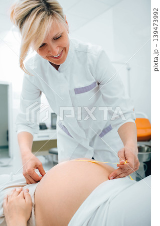 Pregnant woman being examined by a doctor at clinic 139473992