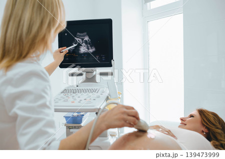 Pregnant woman having sonogram at clinic. pregnant patient ultrasound exam Pregnant woman having sonogram at clinic. pregnant patient ultrasound exam 139473999