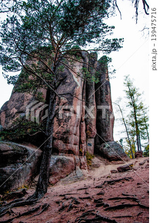 Landscape of Siberia mountains Stolbi, rock Feathers range in haze summer Landscape of Siberia mountains Stolbi, rock Feathers range in haze summer 139475716