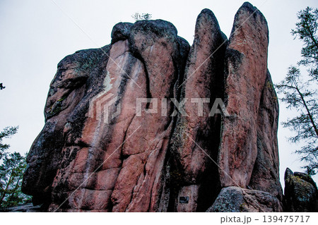 Landscape of Siberia mountains Stolbi, rock Feathers range in haze summer Landscape of Siberia mountains Stolbi, rock Feathers range in haze summer 139475717