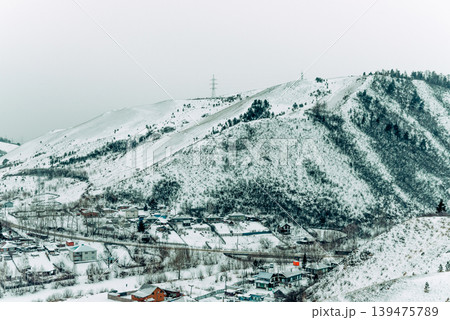 Landscape of snowy Siberia Krasnoyarsk mountains, peaks range in haze winter Landscape of snowy Siberia Krasnoyarsk mountains, peaks range in haze winter 139475789