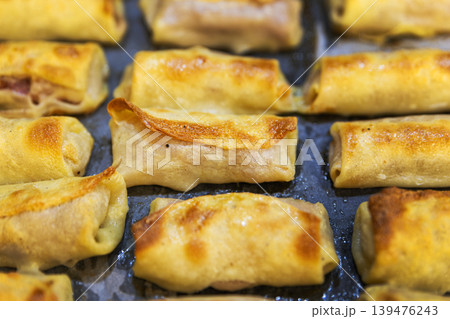 Macro Shot of Golden Brown Toasted Crepe Rolls with Meat Filling Macro Shot of Golden Brown Toasted Crepe Rolls with Meat Filling 139476243