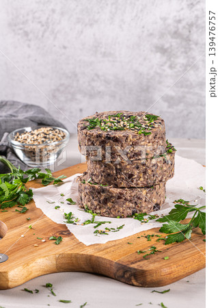 Raw veggie burger with black beans on wood countertop. Raw veggie burger with black beans on wood countertop. 139476757