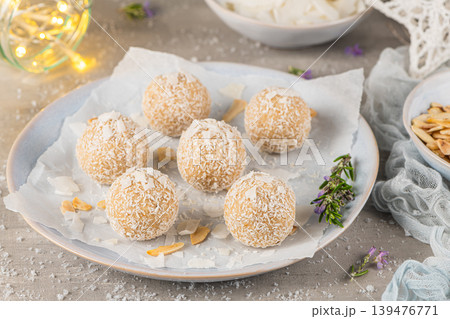 Homemade sweet white chocolate and coconut in a plate. Raffaello candy - snowball truffles on a Christmas table. 139476771