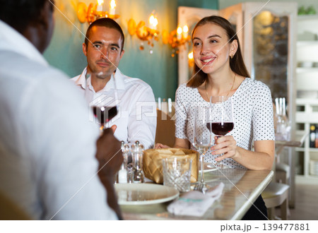 Couple and their friend in the restaurant Couple and their friend in the restaurant 139477881