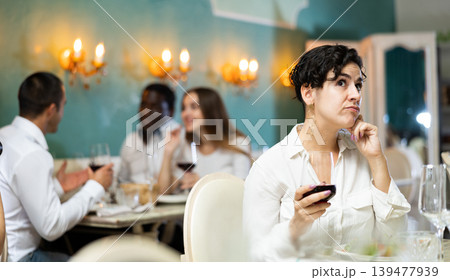 Sad woman with glass at the restaurant 139477939