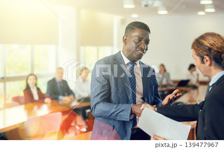 Middle aged african manager welcoming a new white male employee Middle aged african manager welcoming a new white male employee 139477967