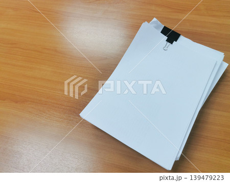 Stack of Clipped Documents on Wooden Office Desk Stack of Clipped Documents on Wooden Office Desk 139479223