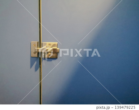 Close-Up of Blue Restroom Stall Door Lock and Latch Close-Up of Blue Restroom Stall Door Lock and Latch 139479225