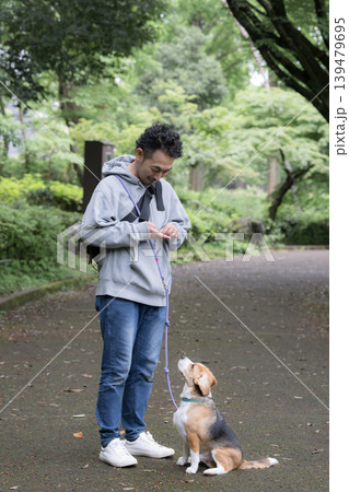 ビーグルを飼う男性、犬と散歩する笑顔ポートレート、躾や訓練のイメージの顔無し注目させるアイコンタクト ビーグルを飼う男性、犬と散歩する笑顔ポートレート、躾や訓練のイメージの顔無し注目させるアイコンタクト 139479695