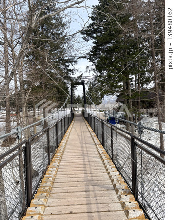Suspension bridge in fukidashi park in winter Season in Hokkaido, Japan Suspension bridge in fukidashi park in winter Season in Hokkaido, Japan 139480162