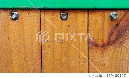 Rustic Wood Fence Texture with Metal Bolts and Green Trim 139480197