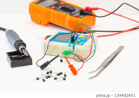 Multifunctional Semiconductor Components Tester, multimeter with test probes, a soldering iron, and tools Multifunctional Semiconductor Components Tester, multimeter with test probes, a soldering iron, and tools 139482651