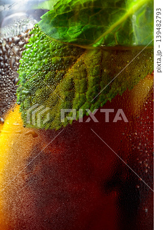 Cocktail with lemon, ice and mint in misted glass. Cocktail with lemon, ice and mint in misted glass. 139482793