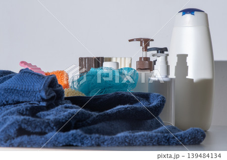 Wash body and hair in the bathroom. Towel and washcloth, Bottles of shampoo, lotion and liquid soap. Shower gel at home white background. Wash body and hair in the bathroom. Towel and washcloth, Bottles of shampoo, lotion and liquid soap. Shower gel at home white background. 139484134