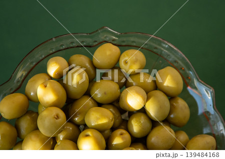 Green olives fruit close up top view, food background Green olives fruit close up top view, food background 139484168