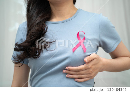 Asian woman with pink ribbon, World Breast Cancer Day at October. 139484543