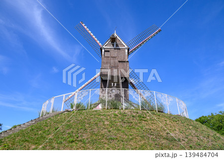 Traditional wooden windmill in Medieval Old Town and UNESCO World Culture Heritage site of Bruges in West Flanders, Belgium 139484704