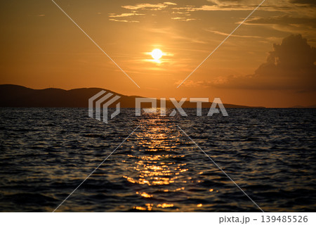 Golden sunset over ocean with island silhouettes 139485526