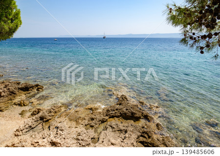 Rocky coast with clear turquoise sea and sailboats 139485606