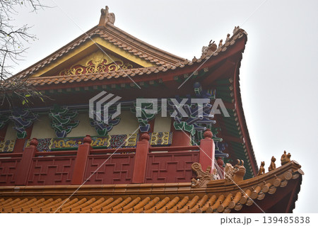 Ornate chinese temple roof with colorful eaves and red balcony Ornate chinese temple roof with colorful eaves and red balcony 139485838