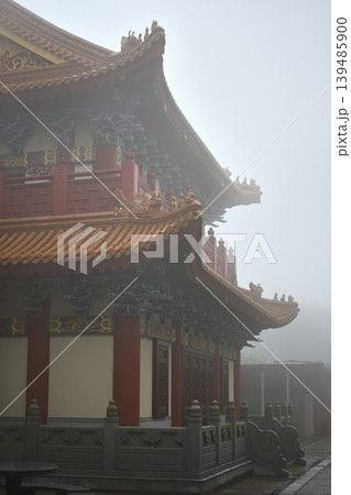 Misty traditional temple roof corner with ornate eaves Misty traditional temple roof corner with ornate eaves 139485900