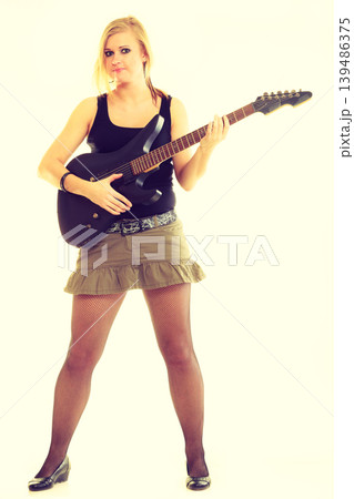 Woman artist player with electric guitar. Woman artist player with electric guitar. 139486375
